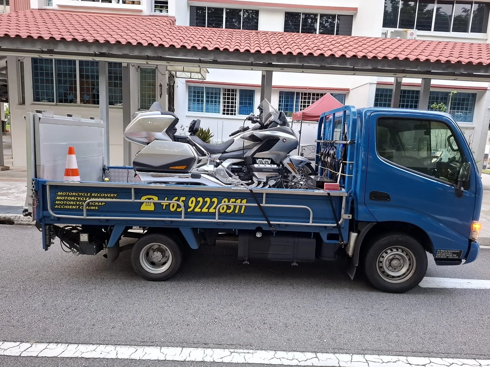 Branded Siva Towing lorry carrying a motorcycle during an islandwide Singapore recovery job