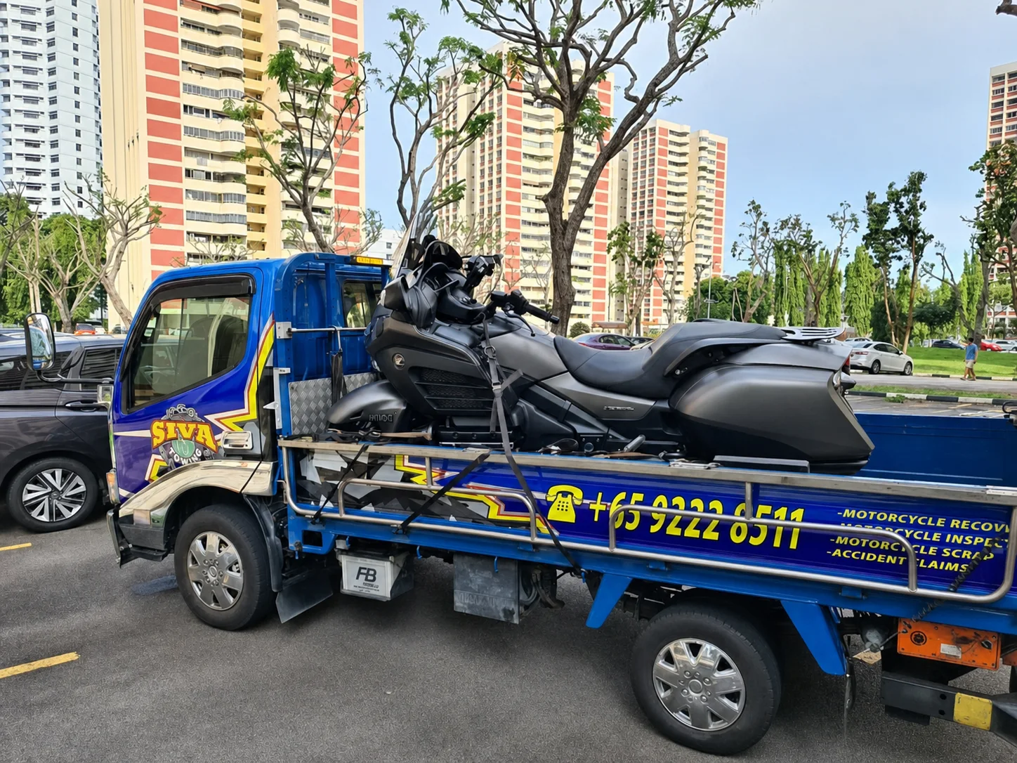 Siva Towing lorry transporting a large touring motorcycle in Singapore