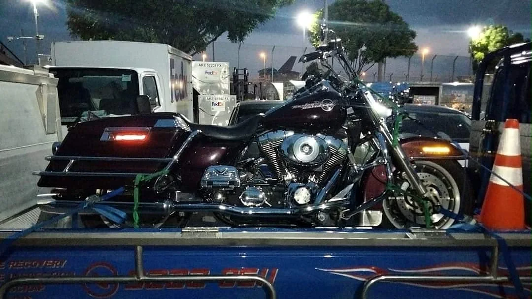 Motorcycle secured during a night accident recovery in Singapore